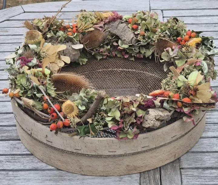 Bloemenkrans op een oude zeef, brocante bij Guirlande Bellem